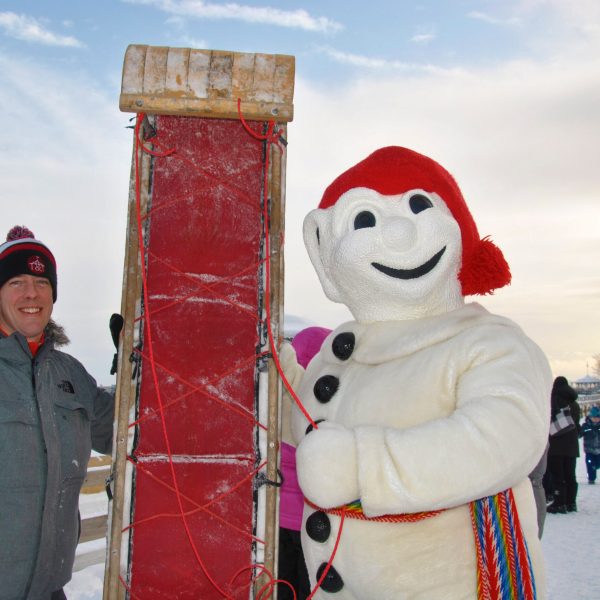 a couple of people that are standing in the snow