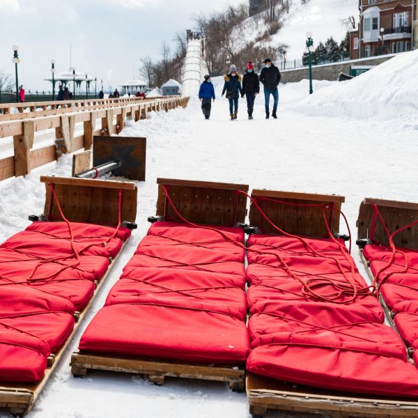 a close up of a mans face with fence in the snow