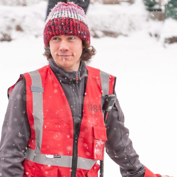 a person wearing a hat skiing in the snow