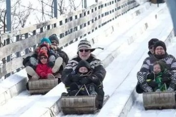 a couple of people that are sitting in the snow