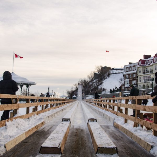 a sign above a snow covered bridge
