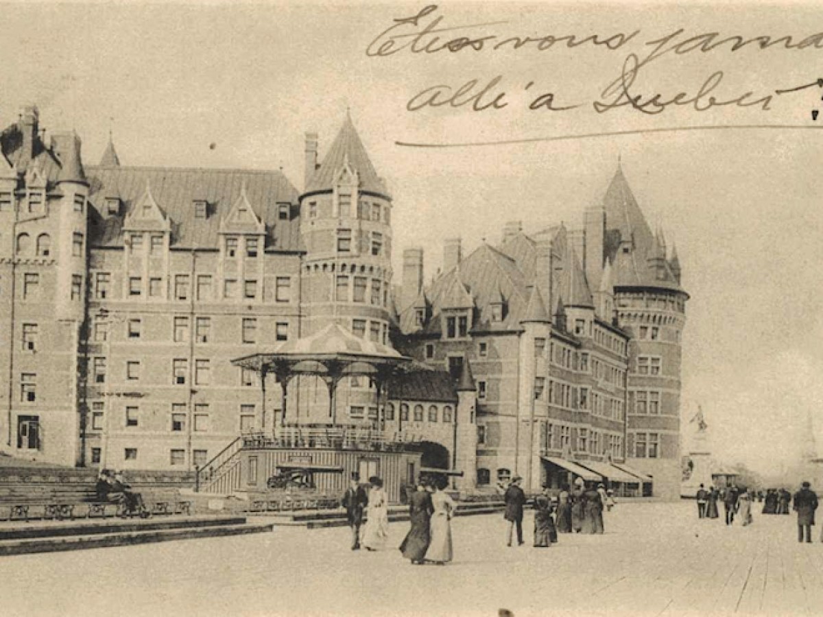 a vintage photo of a horse drawn carriage in front of a building