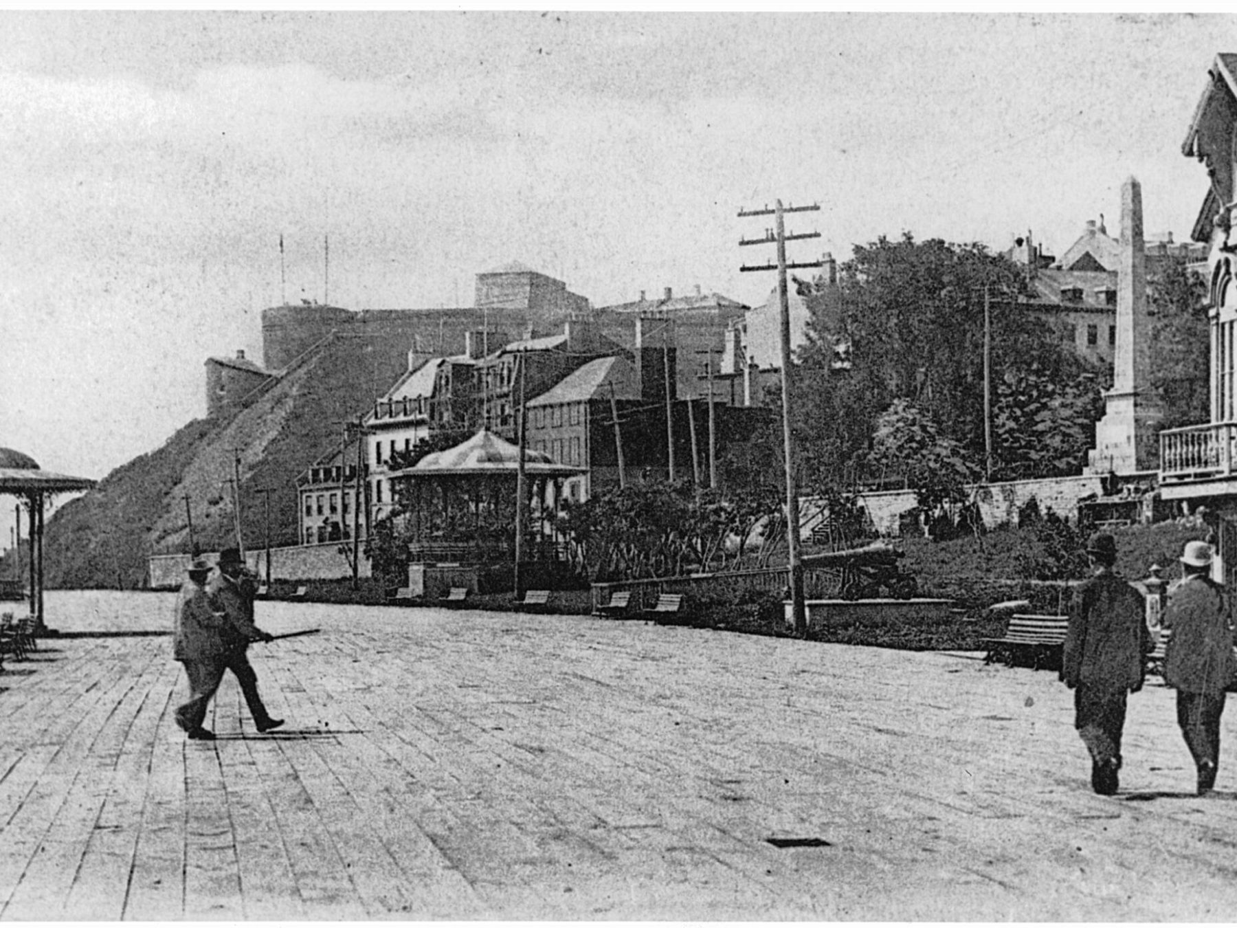 a vintage photo of some people walking on a sidewalk