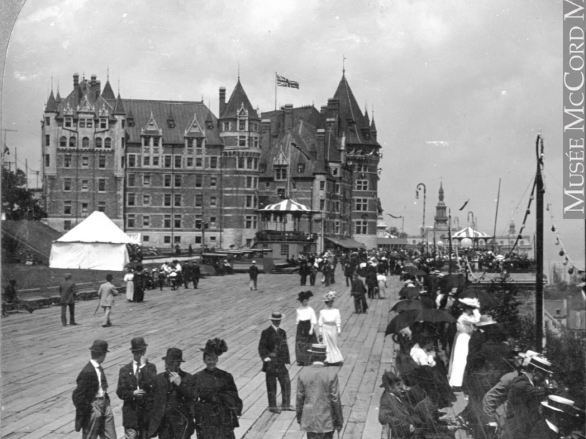 a vintage photo of a group of people standing in front of a building