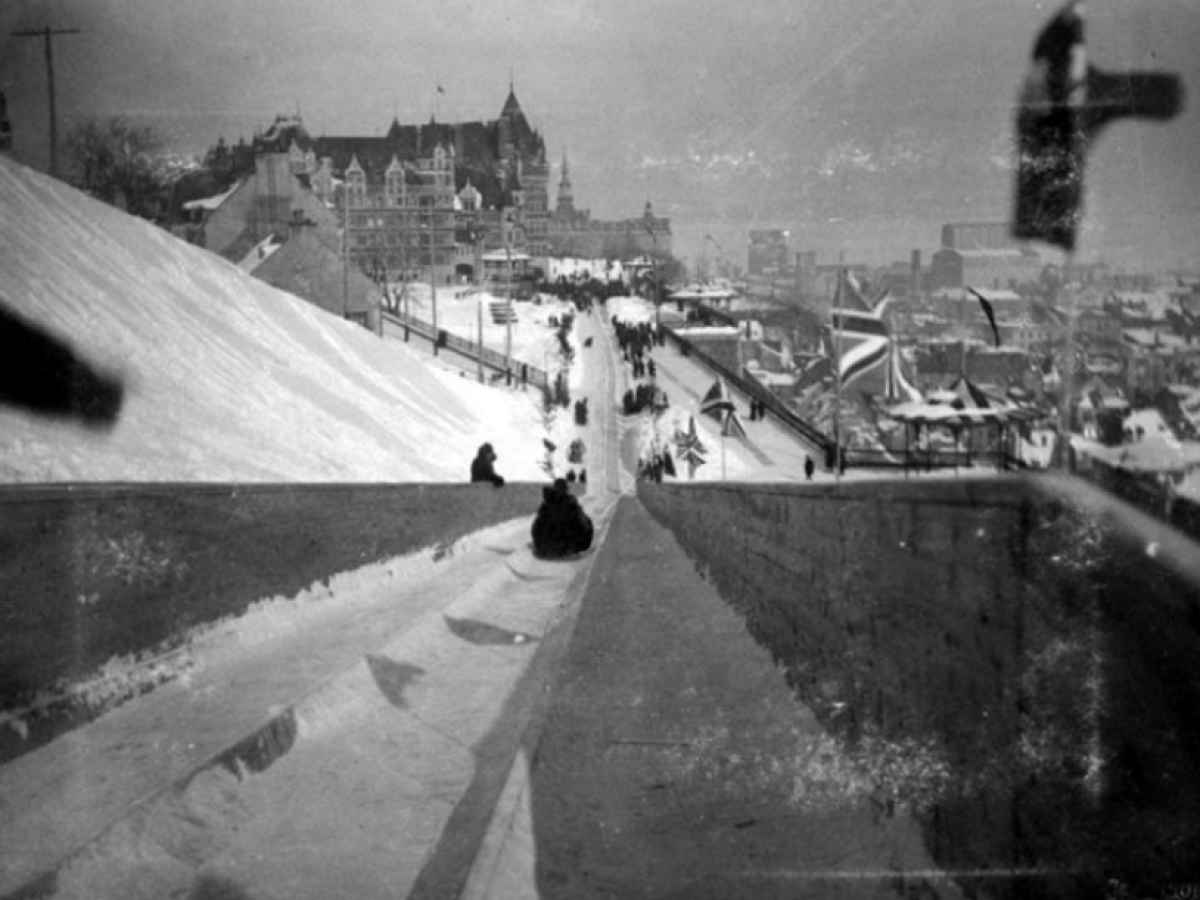 a vintage photo of a man doing a trick at a skate park
