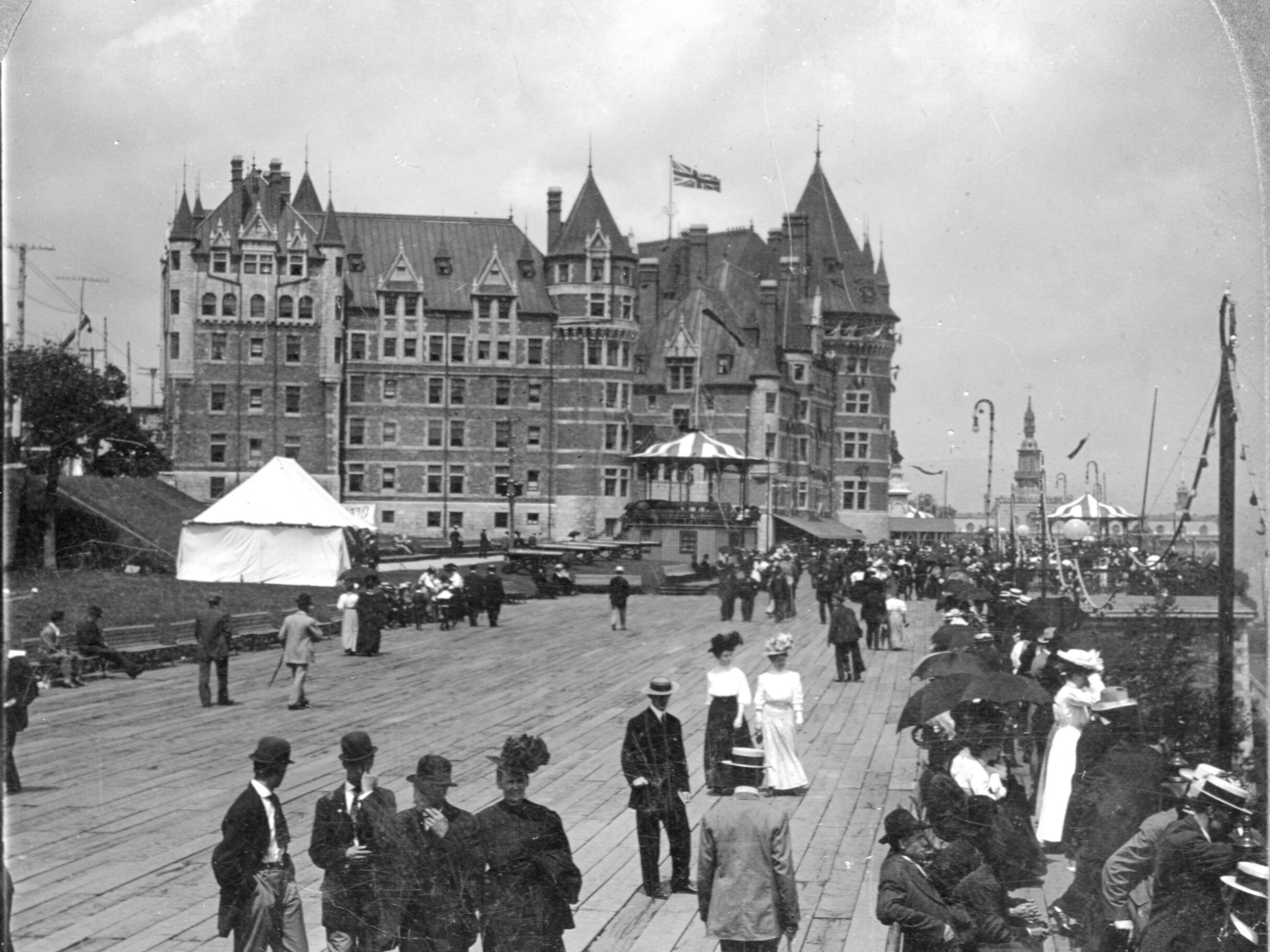 a vintage photo of a group of people standing in front of a building