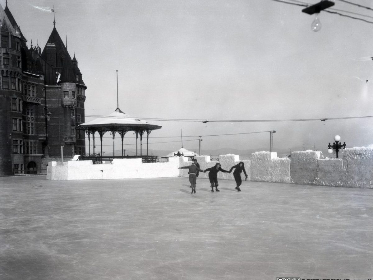 a vintage photo of a group of people standing in front of a building