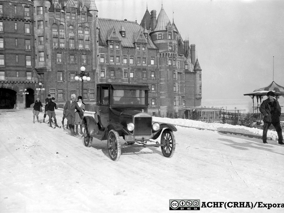 an old photo of a horse drawn carriage in front of a building