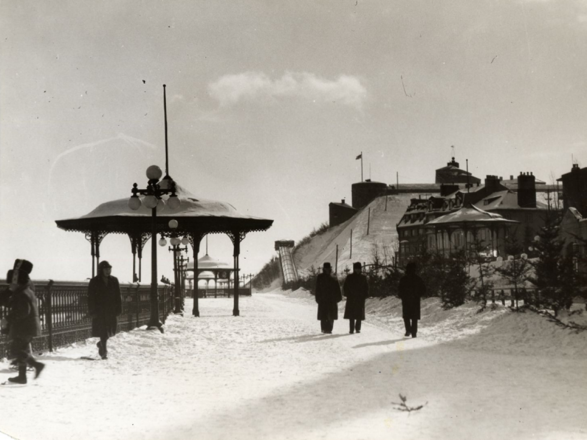 a vintage photo of some people that are standing in the snow
