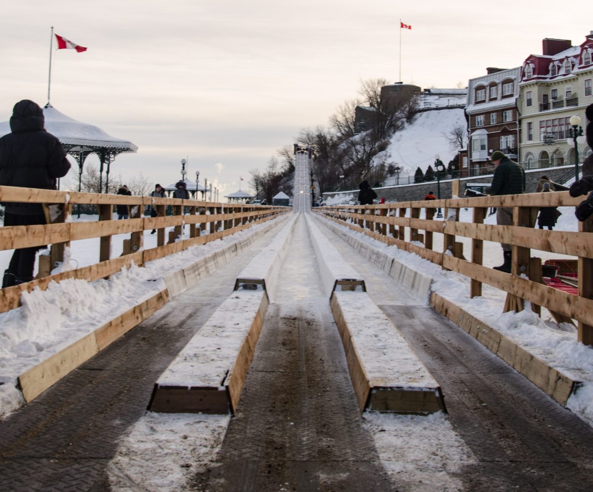 a sign above a snow covered bridge