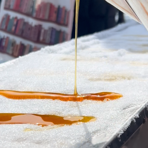 Molten liquid pouring onto a snow-covered surface.