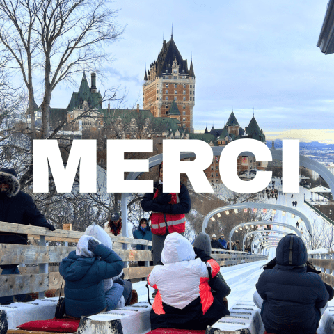 People sledding with a castle-like building in the background, large 'MERCI' text overlay.