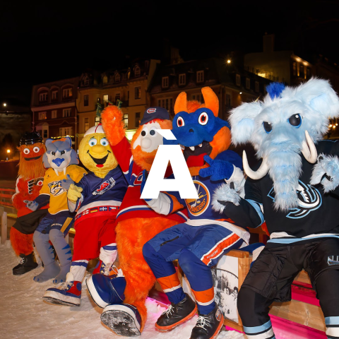 Five colorful sports mascots sitting on a bench, waving at night.