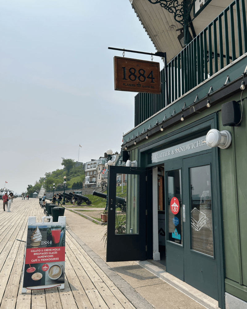 Entrance to cafe with sign '1884,' located on a wooden boardwalk.